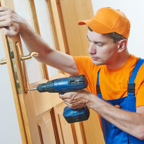 carpenter at door lock installation or repair